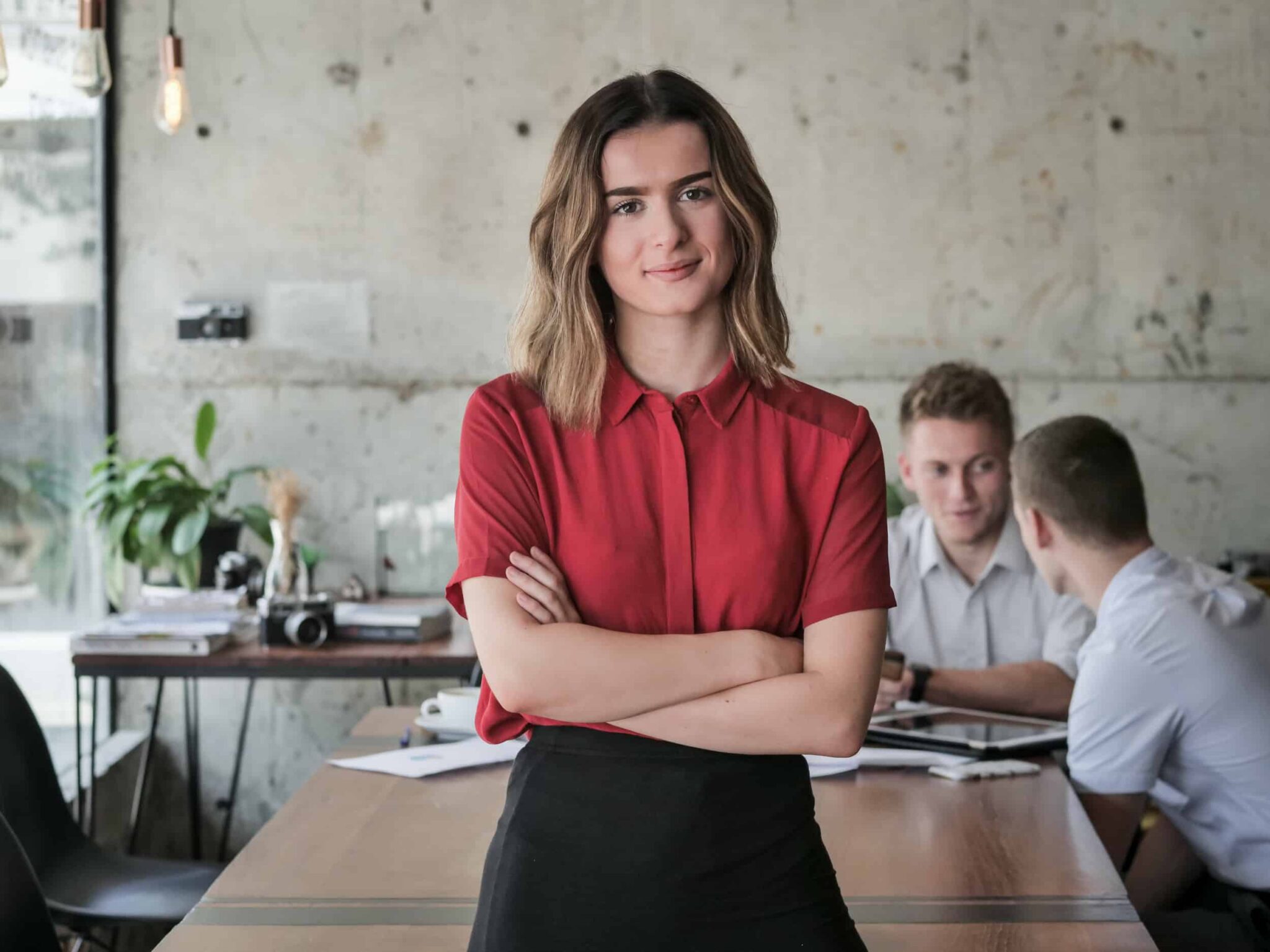 Successful young business woman start up, crossed arm and smiling in workplace