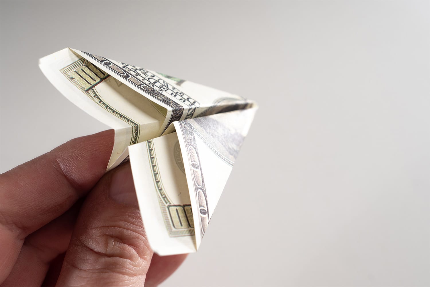 A 10 dollar bill folded into a paper plane.